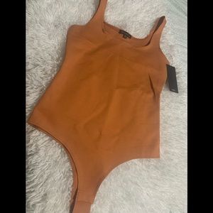 Strechy size small body suit